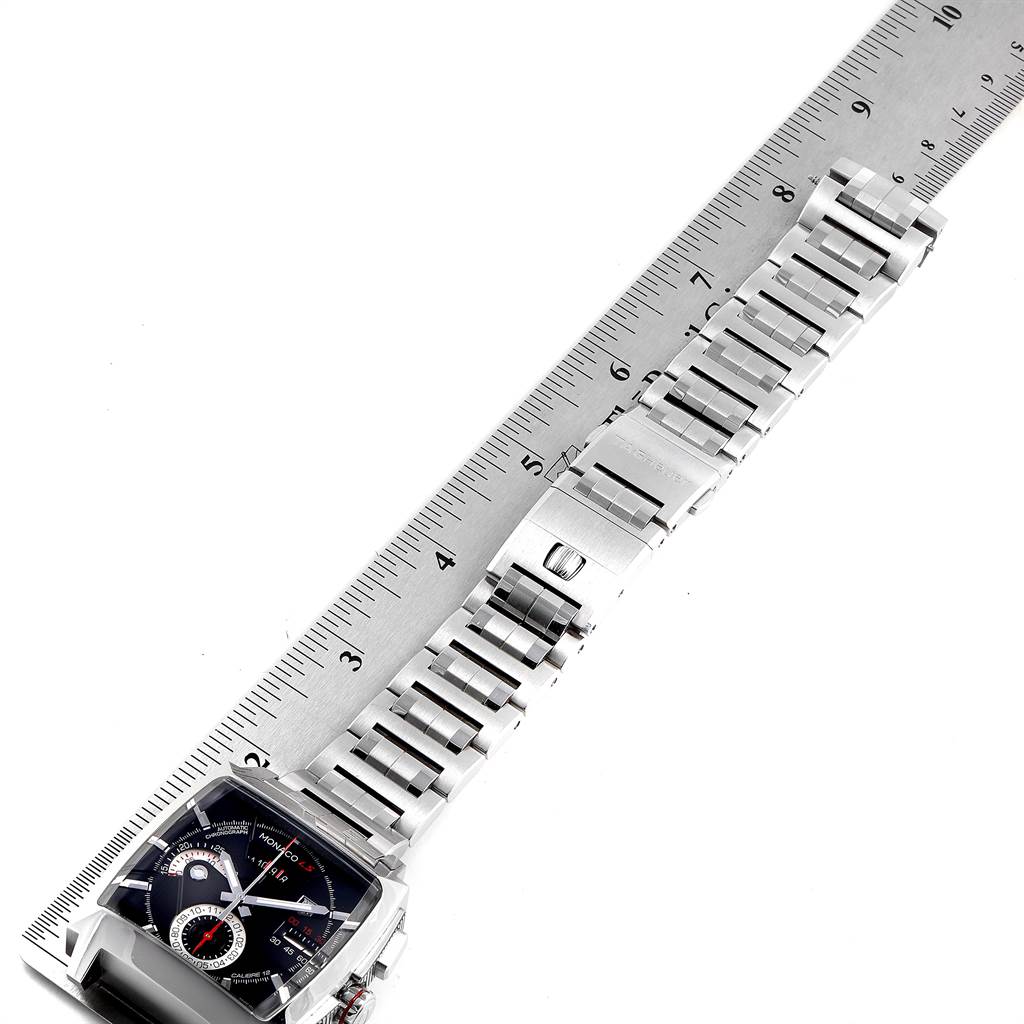 The image shows a top view of the Tag Heuer Monaco CAL2110.BA0781 Men's Stainless Steel Black Dial CAL2110.BA0781 Men's Stainless Steel Black Dial watch with its metal bracelet beside a ruler.
