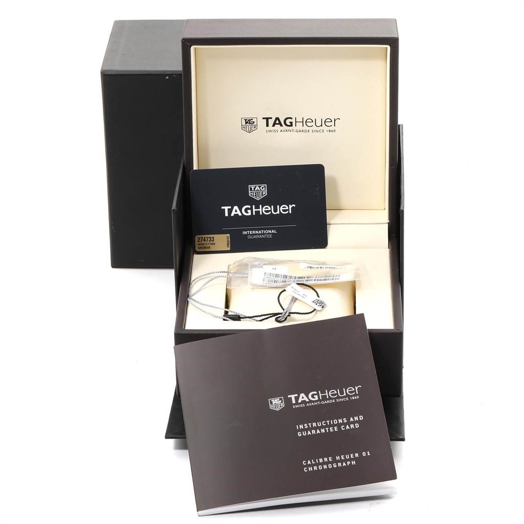 The image shows a Tag Heuer Carrera CAR2A1T.FT6052 Men's Titanium Black Dial CAR2A1T.FT6052 Men's Titanium Black Dial watch box, guarantee card, booklet, and tags viewed from the front.