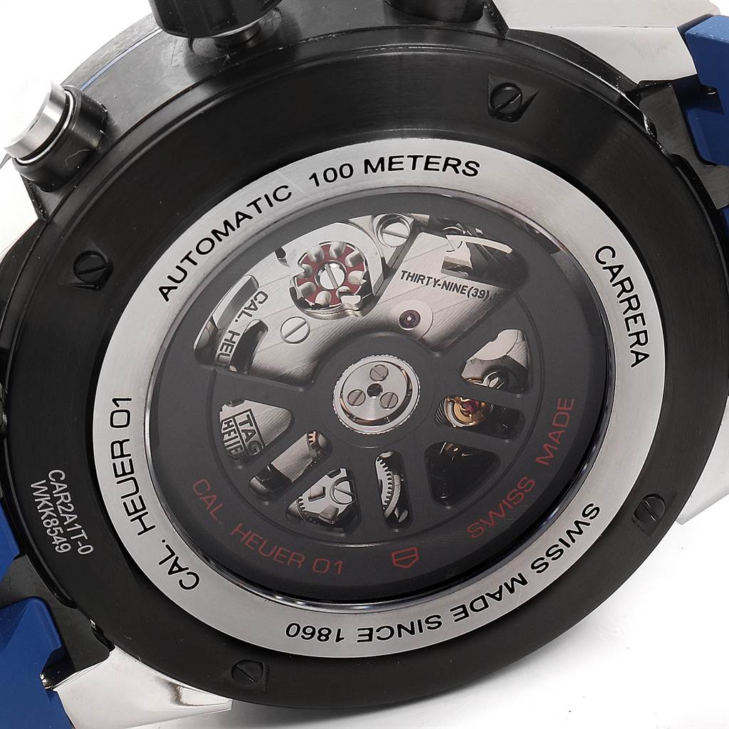 The image shows the rear case of a Tag Heuer Carrera CAR2A1T.FT6052 Men's Titanium Black Dial CAR2A1T.FT6052 Men's Titanium Black Dial watch, exposing its automatic movement and "Cal. Heuer 01" mechanism.