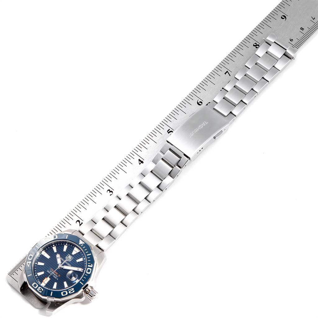 The image shows a top-down view of a Tag Heuer Aquaracer WAY211C.BA0928 Men's Stainless Steel Blue Dial WAY211C.BA0928 Men's Stainless Steel Blue Dial watch with a metal bracelet laid beside a ruler for measurement.