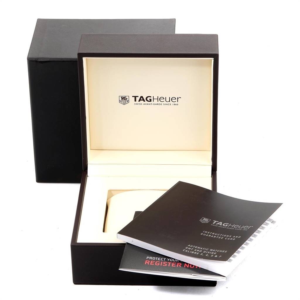 The image shows the open box and manual of a Formula 1 model by Tag Heuer, with no actual watch visible.