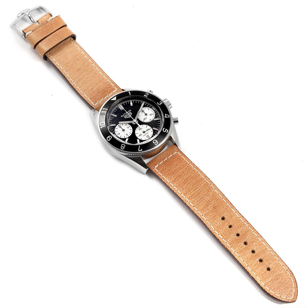 The image shows a top view of a Tag Heuer Autavia CBE2110.FC8226 Men's Stainless Steel Black Dial CBE2110.FC8226 Men's Stainless Steel Black Dial watch with a black dial, black bezel, and a tan leather strap.