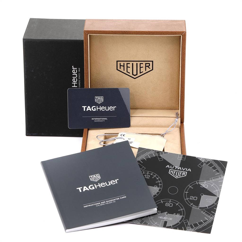 The image shows packaging, a warranty card, and manuals for the Tag Heuer Autavia CBE2110.FC8226 Men's Stainless Steel Black Dial CBE2110.FC8226 Men's Stainless Steel Black Dial model watch.