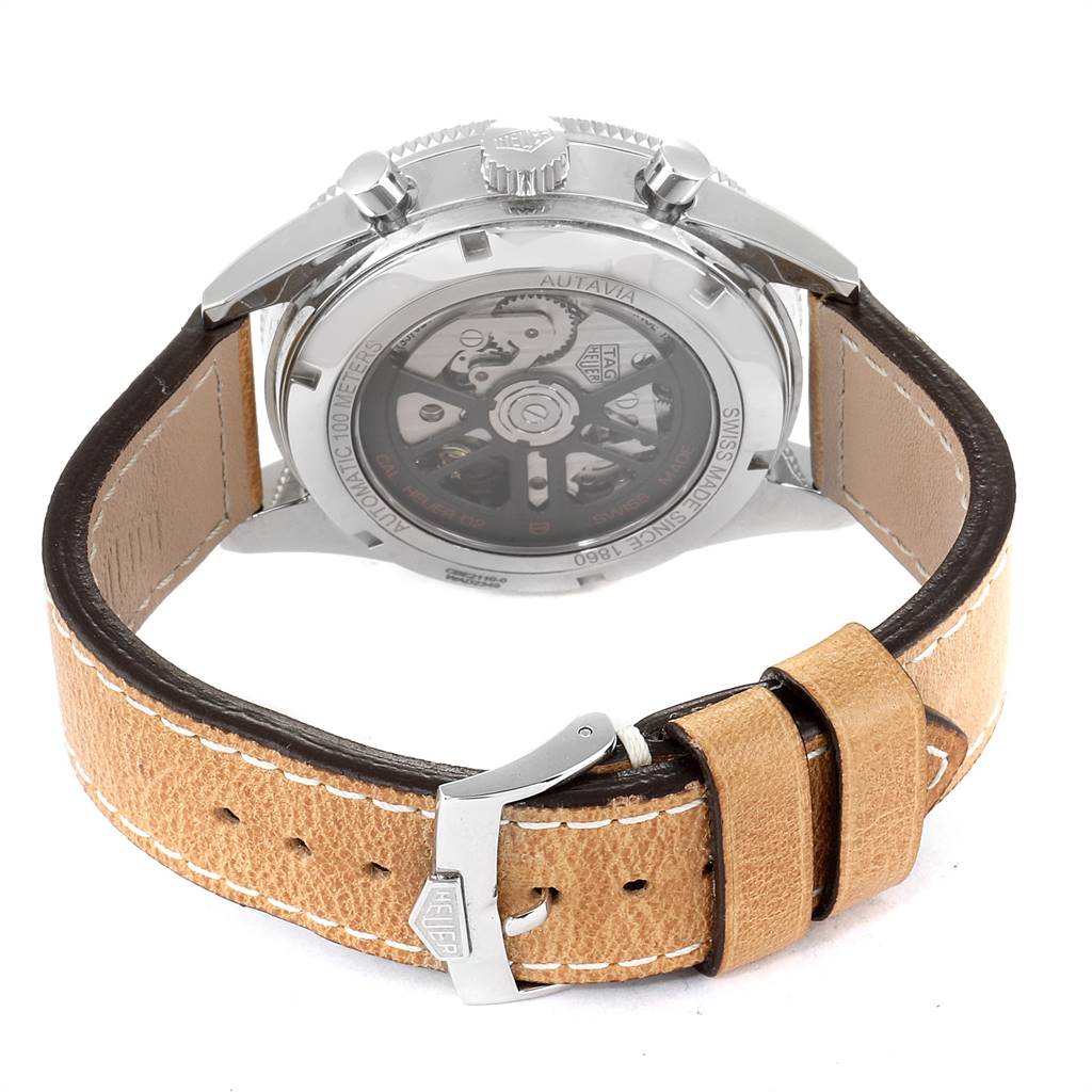 This image shows the back of a Tag Heuer Autavia CBE2110.FC8226 Men's Stainless Steel Black Dial CBE2110.FC8226 Men's Stainless Steel Black Dial watch, highlighting the movement through the transparent case back and the beige leather strap with a buckle.
