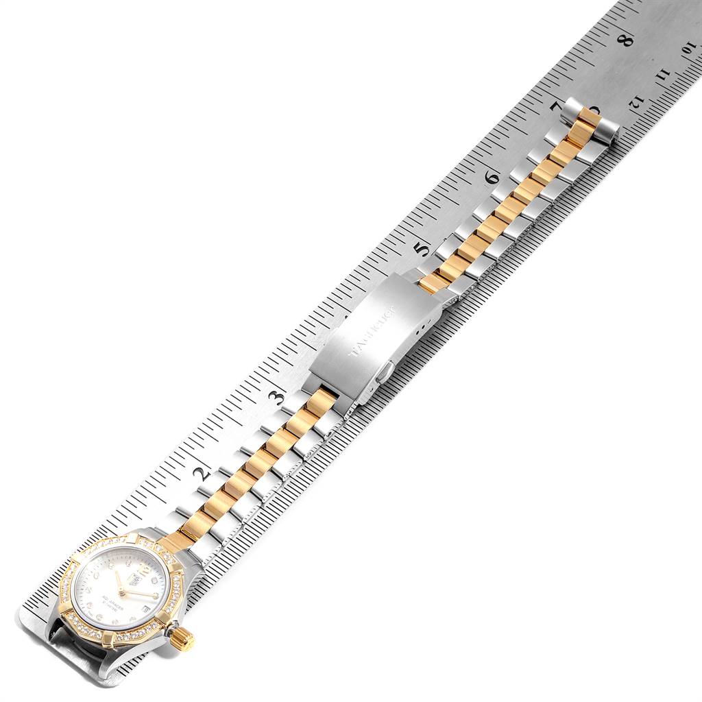 The Tag Heuer Aquaracer WAF1450.BA0825 Women's Steel and Gold (two tone) Mother of Pearl Dial WAF1450.BA0825 Women's Steel and Gold (two tone) Mother of Pearl Dial watch is shown flat with its band extended, measured alongside a ruler.