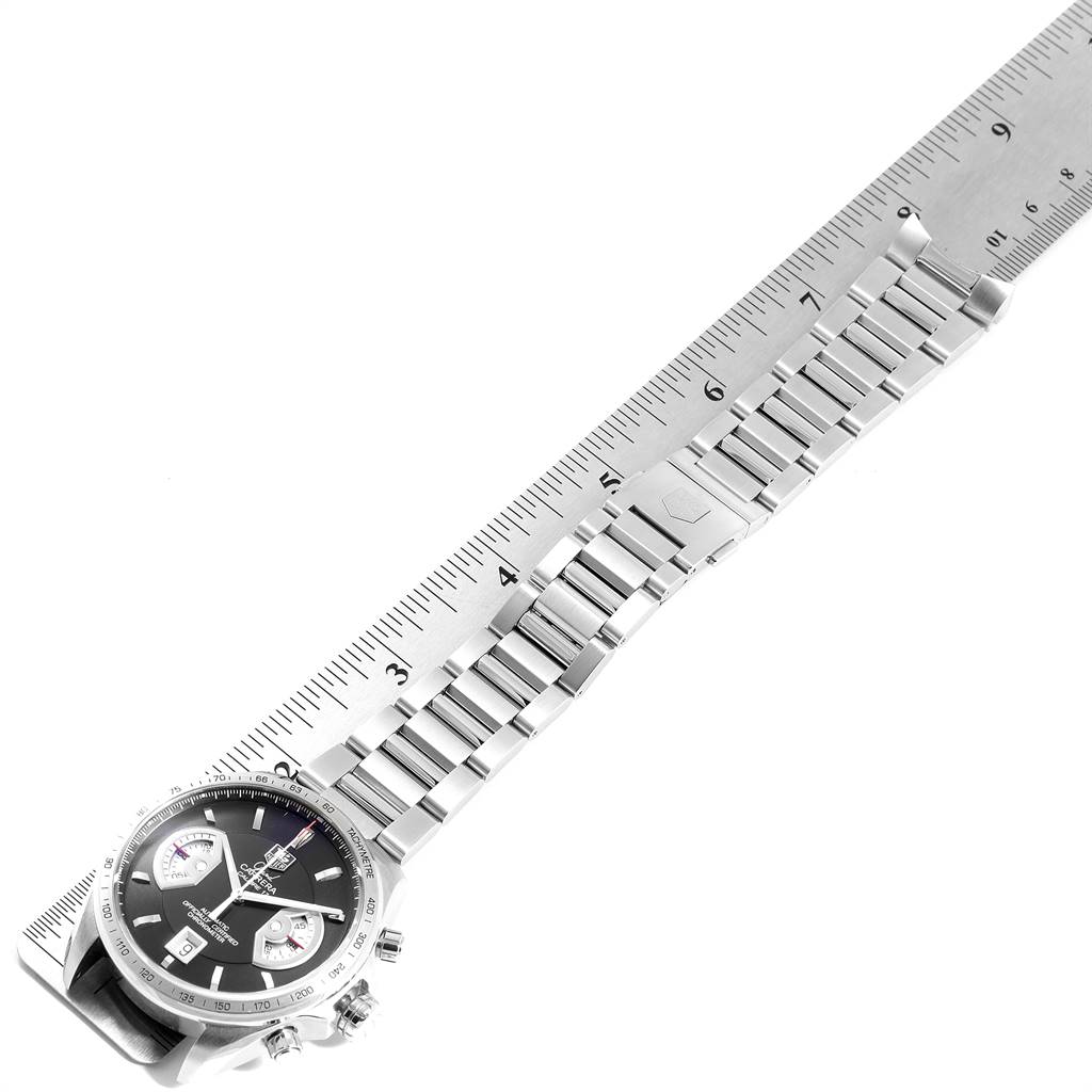 The image shows a Tag Heuer Carrera CAV511A Men's Stainless Steel Black Dial CAV511A Men's Stainless Steel Black Dial watch lying flat, with its metal bracelet and clasp visible, next to a ruler for scale.