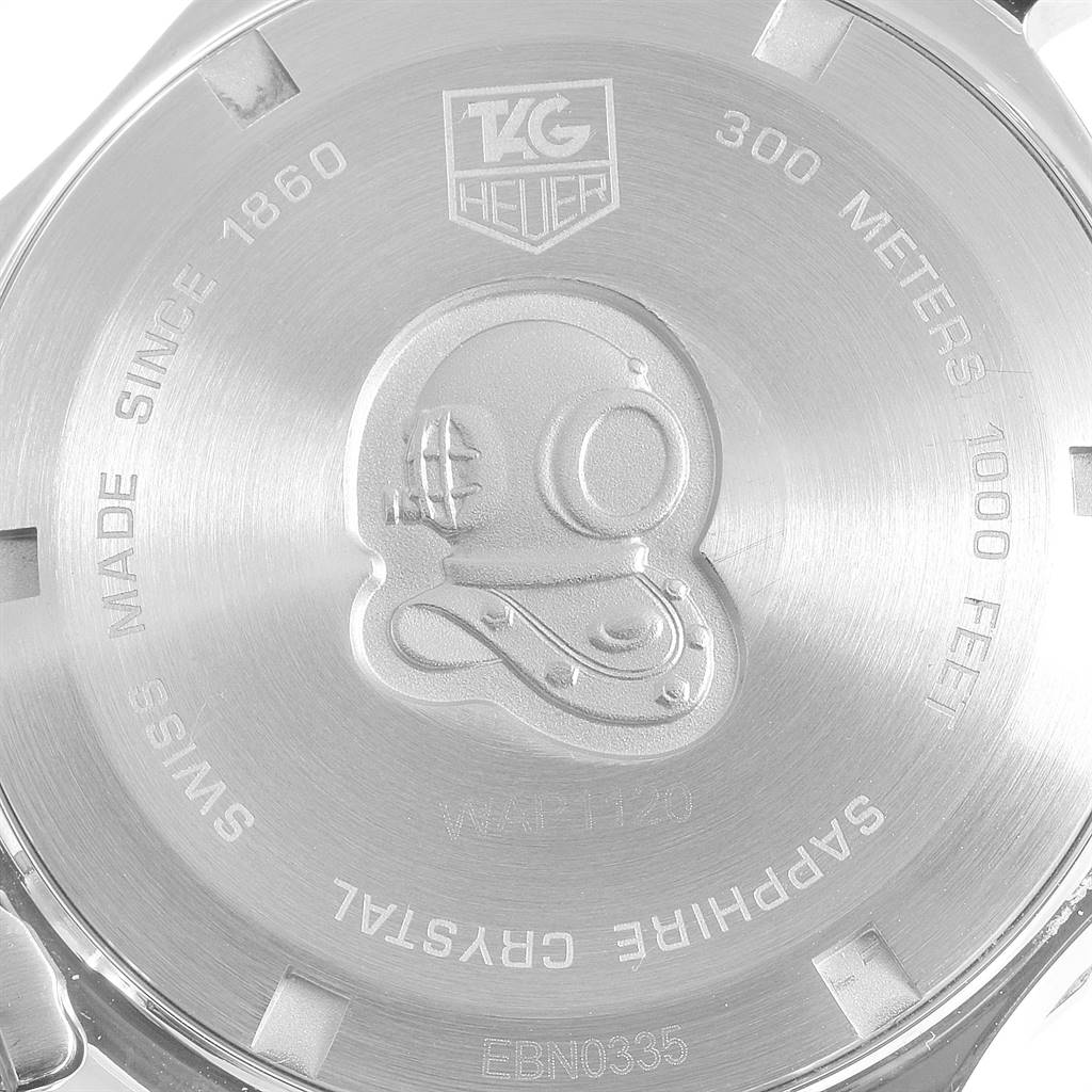 The image shows the back case of a Tag Heuer Aquaracer WAP1120.BB0832 Men's Steel and Gold (two tone) Silver Dial WAP1120.BB0832 Men's Steel and Gold (two tone) Silver Dial watch with engravings and a diver helmet design.