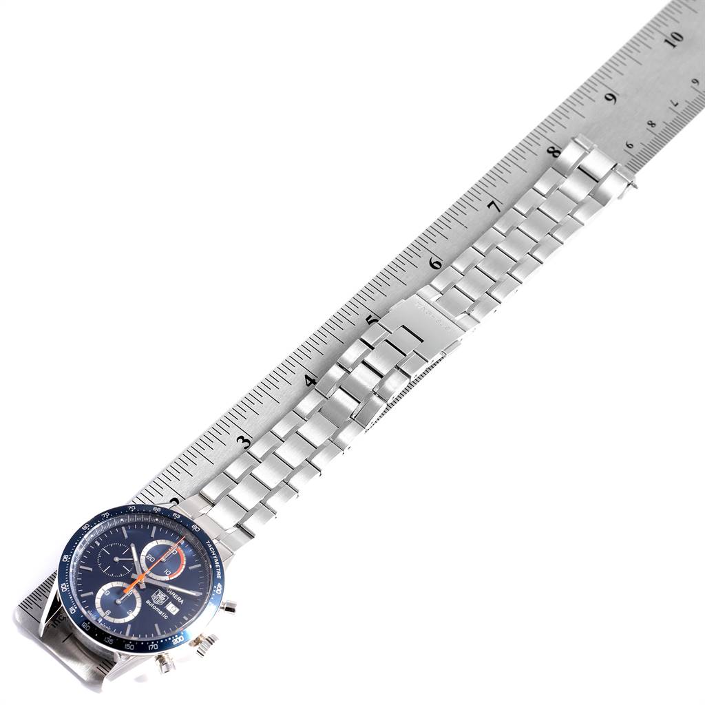 The Tag Heuer Carrera CV2A1V.BA0738 Men's Stainless Steel Blue Dial CV2A1V.BA0738 Men's Stainless Steel Blue Dial watch is shown from a top-down angle, featuring its face and metal bracelet placed alongside a ruler.