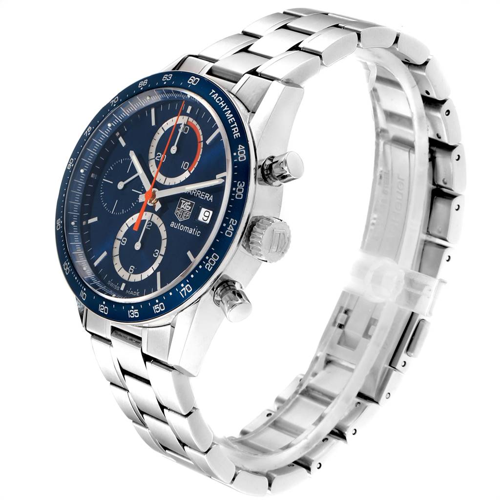 The image shows a side-angle view of the Carrera model by Tag Heuer, showcasing the watch face, bezel, crown, and metal bracelet.