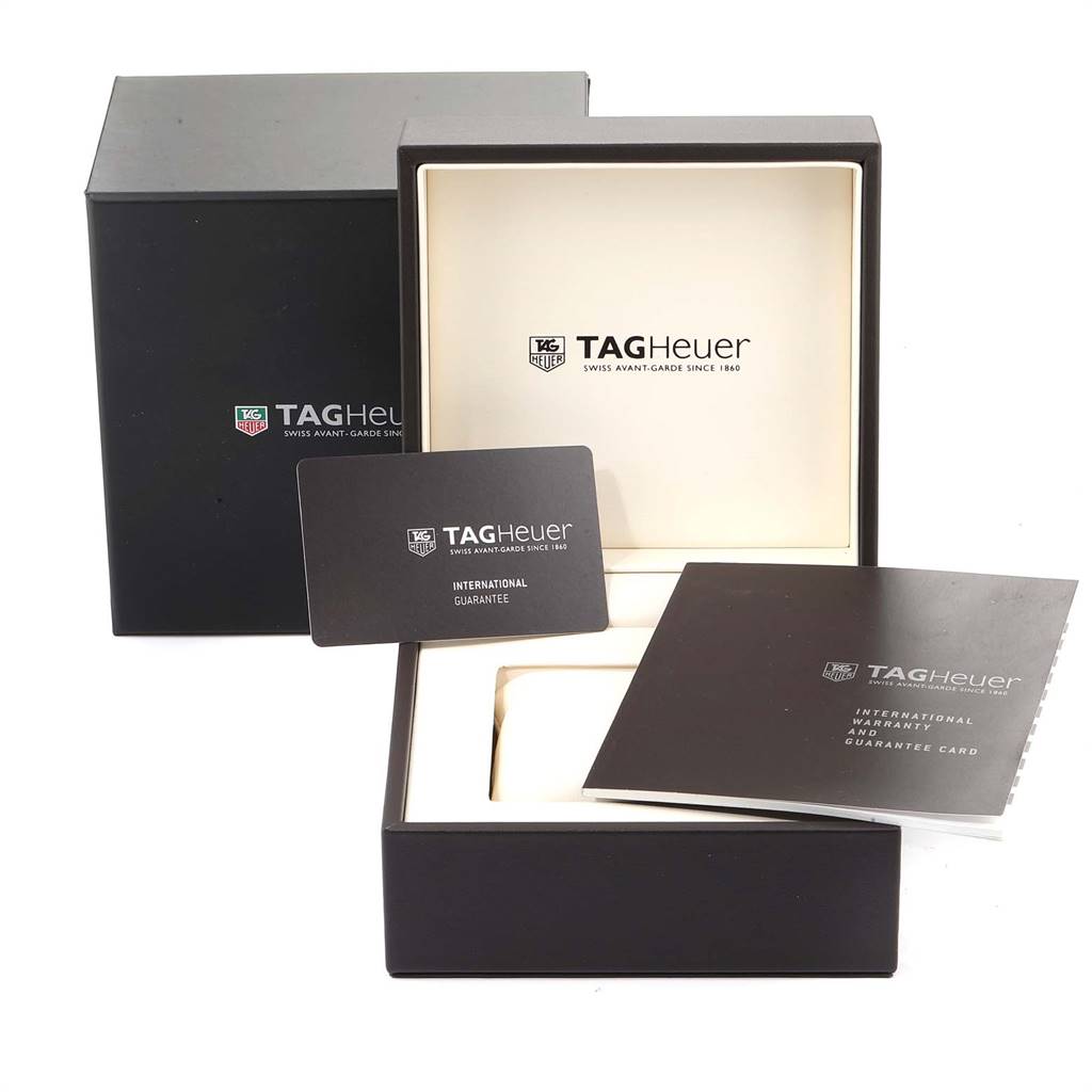 The image shows the box and accessories, including international guarantee cards, for the Carrera model by Tag Heuer.