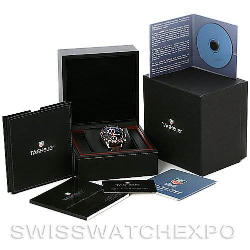 The Tag Heuer Carrera CV2013 Men's Stainless Steel Brown Dial CV2013 Men's Stainless Steel Brown Dial watch is displayed in its open black box, surrounded by documents and packaging materials.