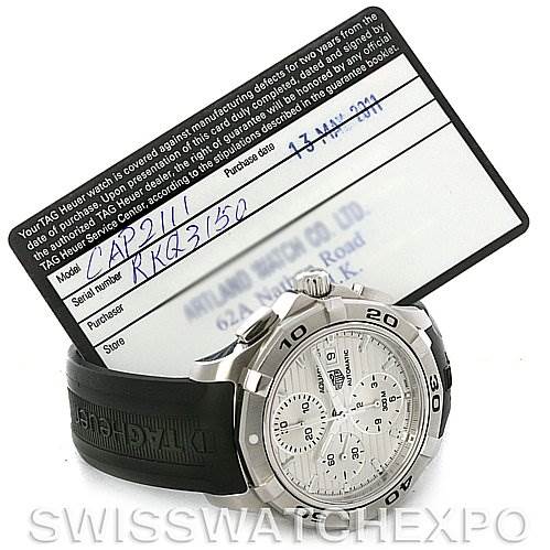 The image shows a Tag Heuer Aquaracer CAP2111.FT6028 Men's Stainless Steel Silver Dial CAP2111.FT6028 Men's Stainless Steel Silver Dial watch at a front angle with its warranty card visible in the background.