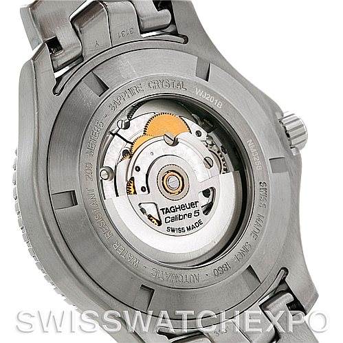 The image shows the back of a Tag Heuer Link WW2110 Men's Stainless Steel Silver Dial WW2110 Men's Stainless Steel Silver Dial model watch, revealing the movement with "Calibre 5" and a transparent case back.