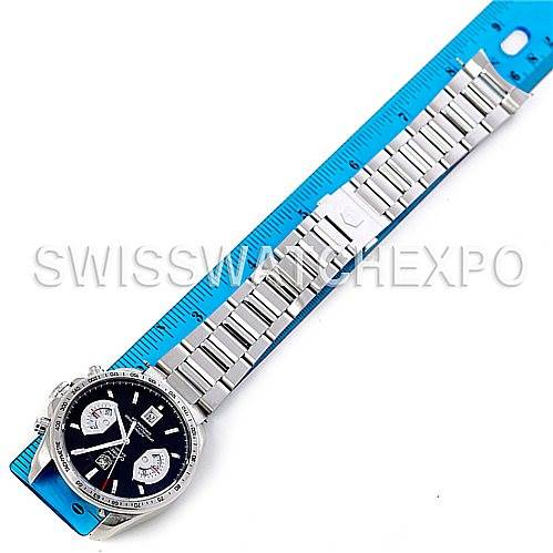 The image shows a Tag Heuer Carrera CAV511A.BA0902 Men's Stainless Steel Black Dial CAV511A.BA0902 Men's Stainless Steel Black Dial watch laid flat alongside a blue ruler, displaying its face and full metal strap.