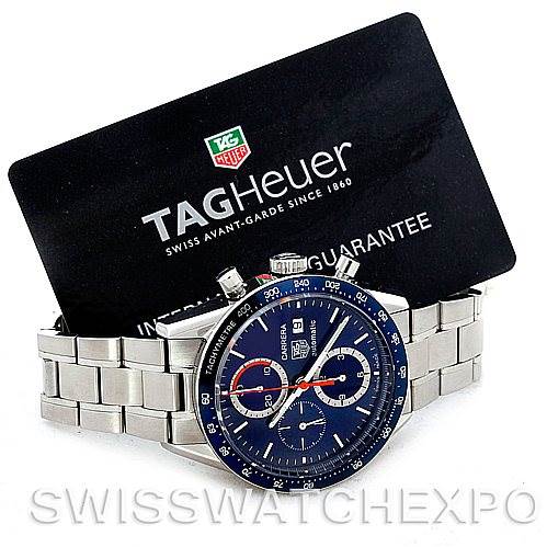 This image shows a side angle of the Tag Heuer Carrera CV2015 Men's Stainless Steel Blue Dial CV2015 Men's Stainless Steel Blue Dial watch and the official guarantee card.