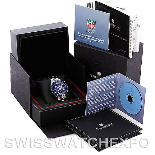 The image shows a Tag Heuer Carrera CV2015 Men's Stainless Steel Blue Dial CV2015 Men's Stainless Steel Blue Dial watch in its box, accompanied by booklets, a CD, and warranty cards.