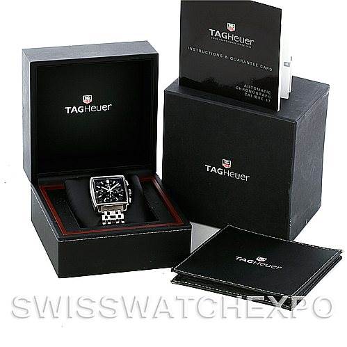 The image shows the Tag Heuer Monaco CW2111.BA078 Men's Stainless Steel Black Dial CW2111.BA078 Men's Stainless Steel Black Dial watch in its box, with additional packaging and instruction manuals displayed around it.