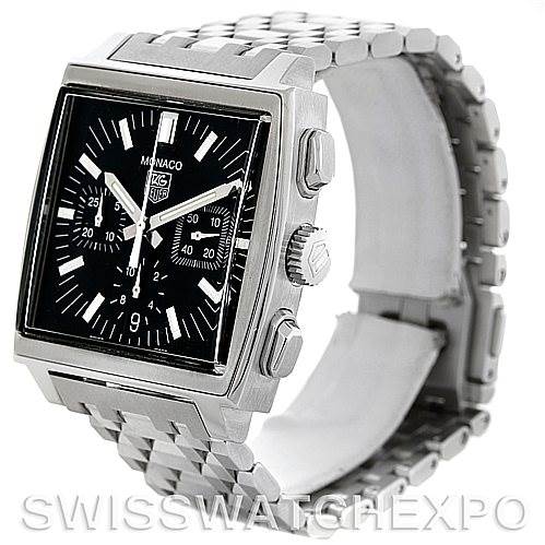 The image shows an angled view of the Tag Heuer Monaco CW2111.BA078 Men's Stainless Steel Black Dial CW2111.BA078 Men's Stainless Steel Black Dial watch, highlighting the face, buttons, crown, and a portion of the metal bracelet.