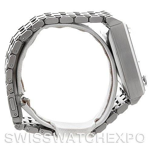 The image shows a side view of a Monaco model Tag Heuer watch, highlighting the stainless steel bracelet and case.
