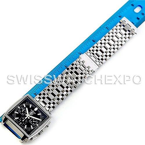 The image shows a flat-lay view of a Tag Heuer Monaco CW2111.BA078 Men's Stainless Steel Black Dial CW2111.BA078 Men's Stainless Steel Black Dial watch with a steel bracelet next to a blue ruler for size reference.