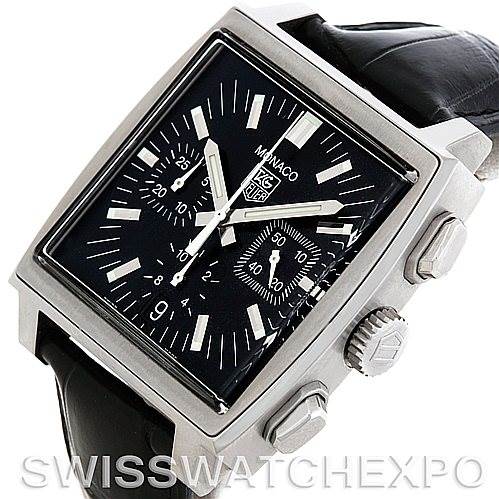 The image shows a Tag Heuer Monaco CW2111 Men's Stainless Steel Black Dial CW2111 Men's Stainless Steel Black Dial watch at a tilted angle, highlighting its square face, dials, and black leather strap.