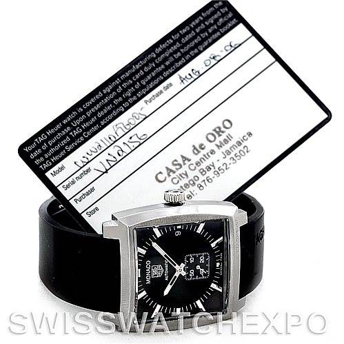 The image shows a Tag Heuer Monaco WW2110 Men
s Black Dial WW2110 Men
s Black Dial watch from a front angle, alongside its warranty card and black strap.