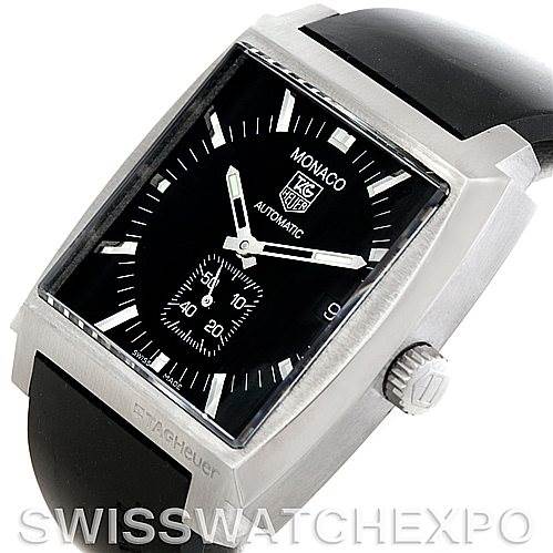 The image shows a Tag Heuer Monaco WW2110 Men
s Black Dial WW2110 Men
s Black Dial model watch at an angled view, highlighting its dial, case, and black strap.