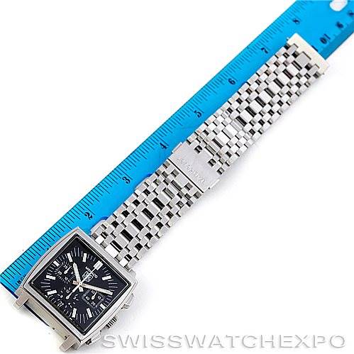 The image shows a top-down view of the Tag Heuer Monaco CW2111 Men's Stainless Steel Black Dial CW2111 Men's Stainless Steel Black Dial watch with a ruler for scale, displaying the face and metal bracelet.