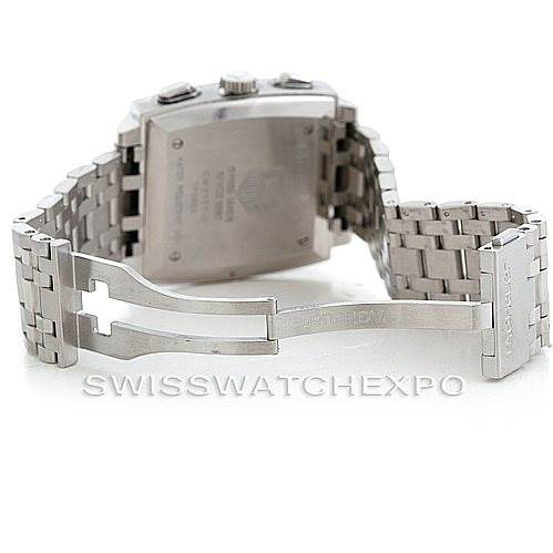 The image shows the back of a Tag Heuer Monaco CW2111 Men's Stainless Steel Black Dial CW2111 Men's Stainless Steel Black Dial watch and its opened metal bracelet clasp.