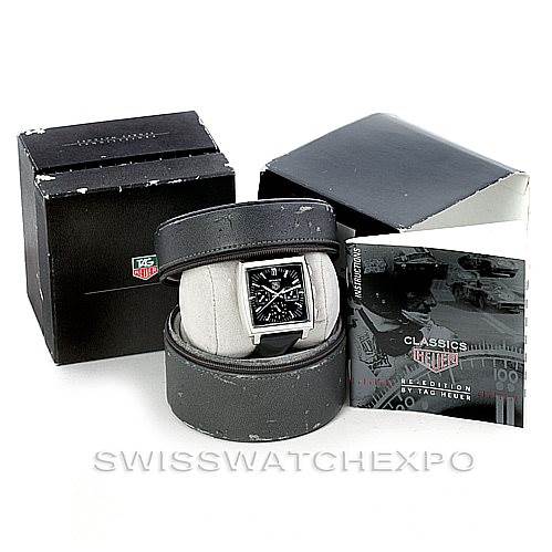 The image shows the Tag Heuer Monaco CW2111 Men's Stainless Steel Black Dial CW2111 Men's Stainless Steel Black Dial watch at a front angle, including its box, case, and user manual.