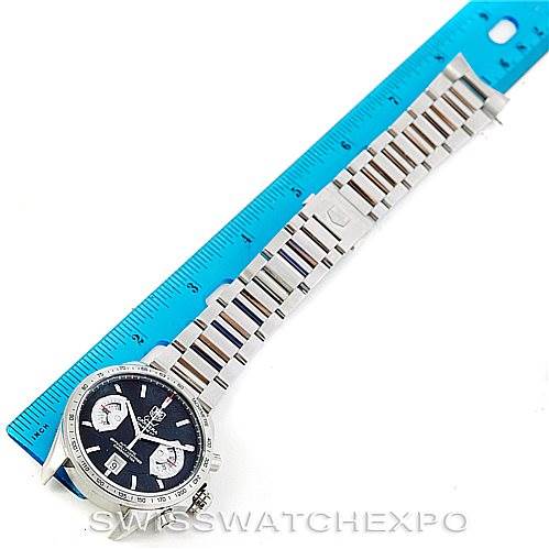 The image shows a top-down view of a Tag Heuer Carrera CAV511A Men
s Stainless Steel Black Dial CAV511A Men
s Stainless Steel Black Dial watch with a metal bracelet, alongside a blue ruler for scale.