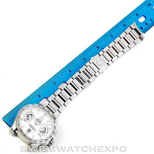 The image shows a Tag Heuer Carrera CAV511B Men
s Stainless Steel Silver Dial CAV511B Men
s Stainless Steel Silver Dial watch laid flat alongside a blue ruler, displaying its face and full metal bracelet.