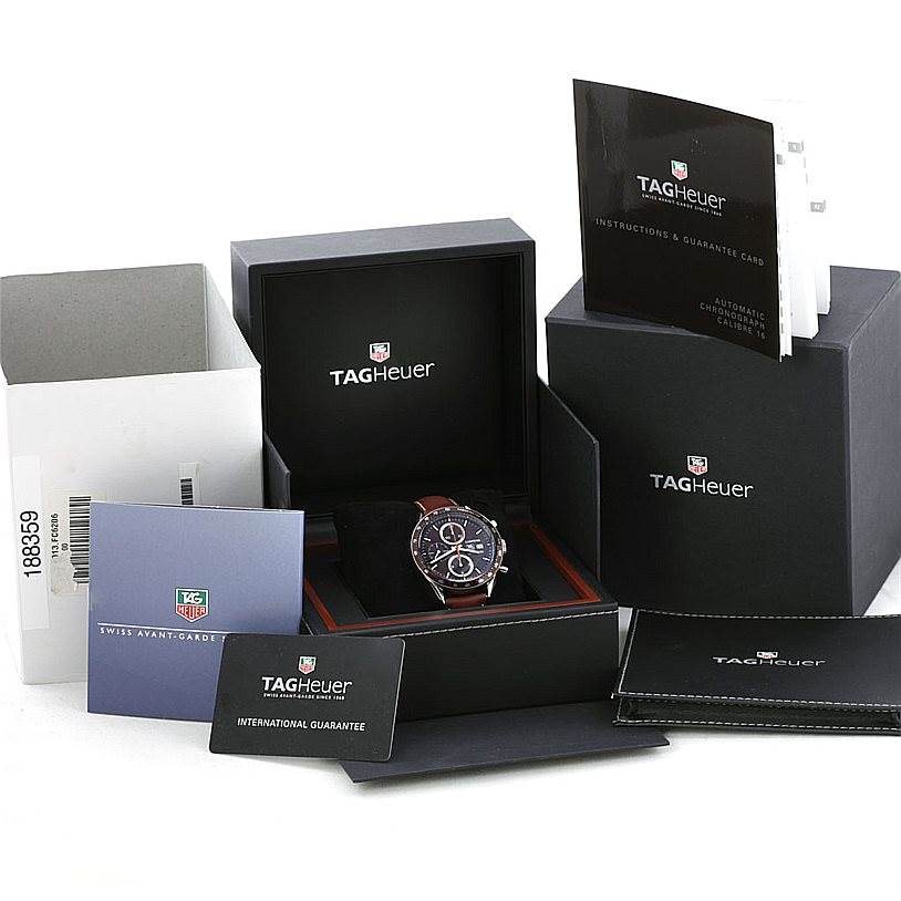 The Tag Heuer Carrera CV2013 Men's Stainless Steel Brown Dial CV2013 Men's Stainless Steel Brown Dial watch is shown from the front along with its box, manuals, and guarantee cards.