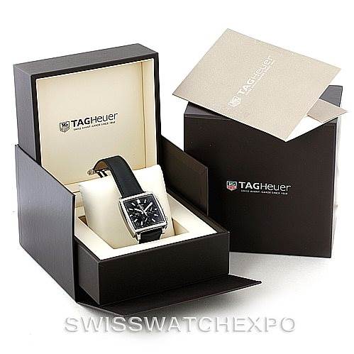 The image shows a Tag Heuer Monaco CW2111 Men
s Stainless Steel Black Dial CW2111 Men
s Stainless Steel Black Dial watch placed in its open box, surrounded by the outer box and documentation.