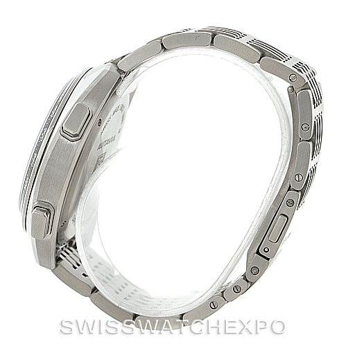 The image shows a side profile view of the Autavia model by Tag Heuer, focusing on the case and metal bracelet.