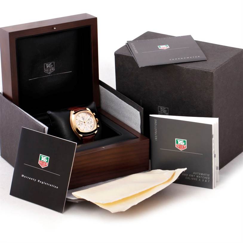 The image shows the Tag Heuer Monza CR514A.FC8145 Yellow Gold Silver Dial CR514A.FC8145 Yellow Gold Silver Dial watch in its open box with manuals and accessories from a front angle.