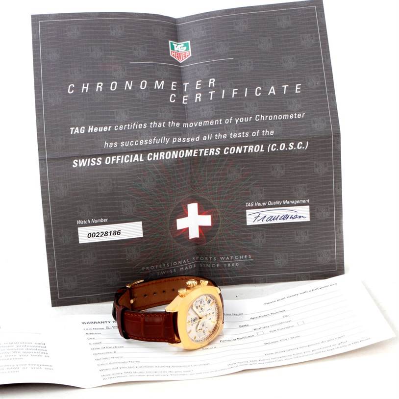 The image shows a Tag Heuer Monza CR514A.FC8145 Yellow Gold Silver Dial CR514A.FC8145 Yellow Gold Silver Dial watch lying flat with its chronometer certificate and other documentation in the background.