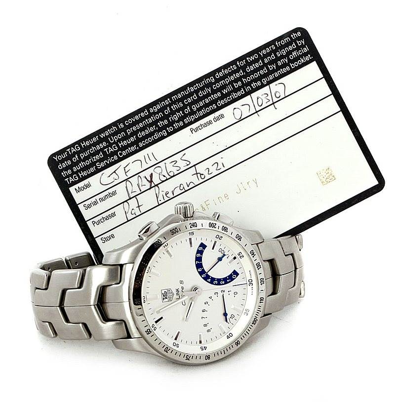 The image shows a Tag Heuer Link CJF2150 Men's Stainless Steel Silver Dial CJF2150 Men's Stainless Steel Silver Dial model watch and its warranty card, angled to display the watch face and bracelet.
