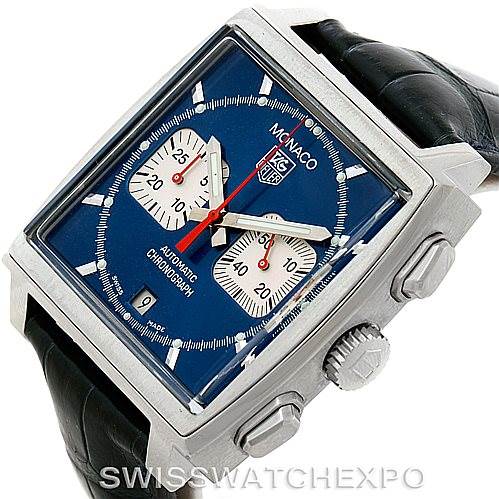 The image shows a Tag Heuer Monaco CW2113 Men's Stainless Steel Blue Dial CW2113 Men's Stainless Steel Blue Dial watch from a slight angle, highlighting its blue dial, chronograph subdials, and black leather strap.