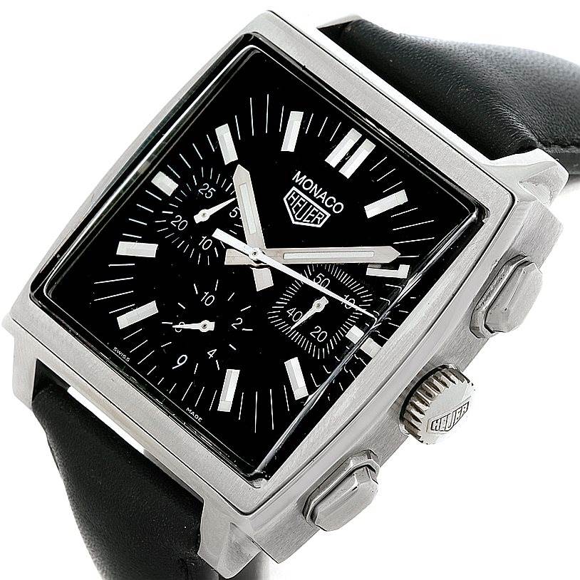This Monaco model by Tag Heuer is shown at an oblique angle, highlighting its square face, black dial, pushers, and crown.