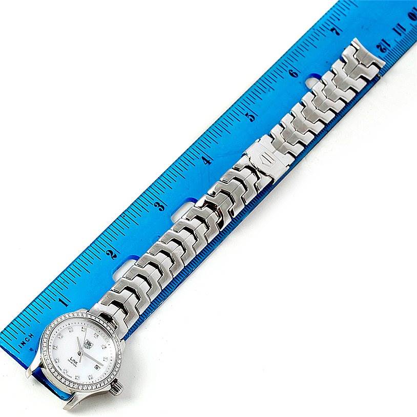 The image shows a Tag Heuer Link WJF1319 Women's Stainless Steel Mother of Pearl Dial WJF1319 Women's Stainless Steel Mother of Pearl Dial model watch, specifically the watch face and bracelet, placed next to a ruler.