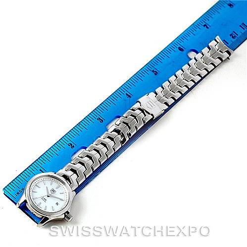 The image shows a top-down view of a Tag Heuer Link WJF1310 Women's Stainless Steel Mother of Pearl Dial WJF1310 Women's Stainless Steel Mother of Pearl Dial model watch placed next to a blue ruler for measurement.