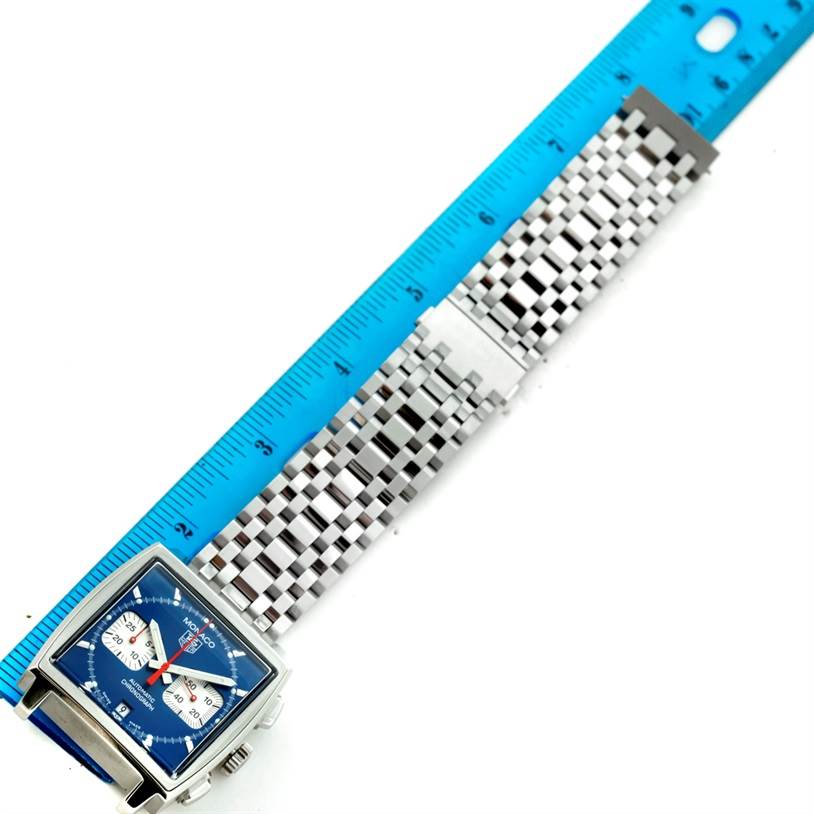 The image shows the face and full metal band of a Tag Heuer Monaco CW2113 Men's Stainless Steel Blue Dial CW2113 Men's Stainless Steel Blue Dial watch, measured against a blue ruler.