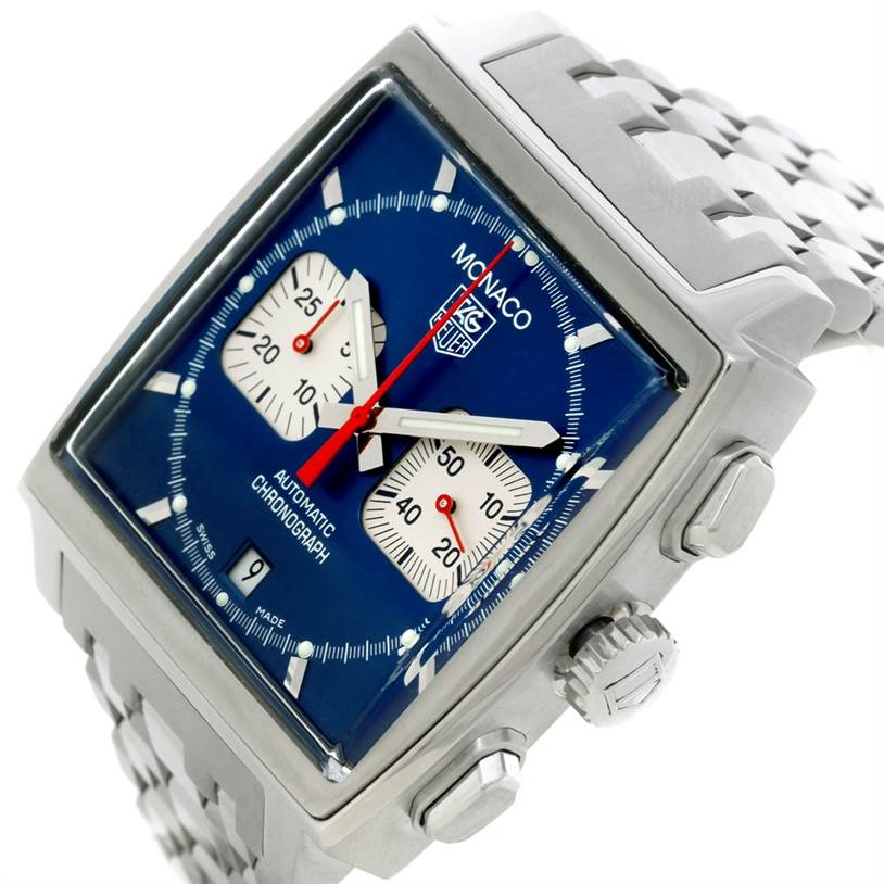 The image shows a slanted angle of the Tag Heuer Monaco CW2113 Men's Stainless Steel Blue Dial CW2113 Men's Stainless Steel Blue Dial model, highlighting its blue dial, chronograph subdials, and stainless steel bracelet.