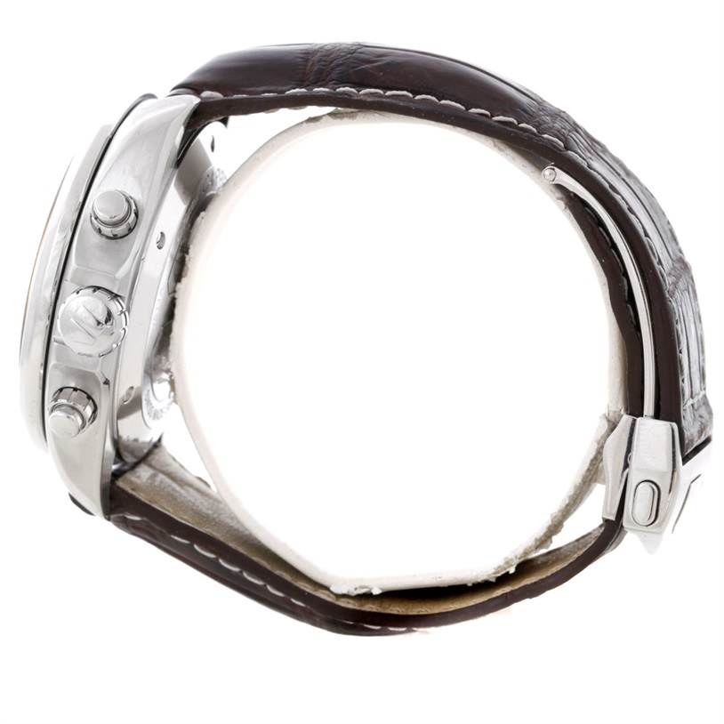 The image shows a side view of a Tag Heuer Carrera CAV511A.FC6225 Men
s Stainless Steel Black Dial CAV511A.FC6225 Men
s Stainless Steel Black Dial watch, highlighting its crown, pushers, and leather strap with a deployment clasp.