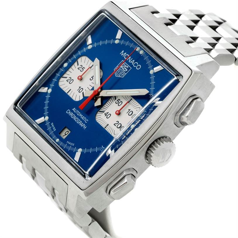 The image shows a side angle view of a Tag Heuer Monaco CW2113 Men's Stainless Steel Blue Dial CW2113 Men's Stainless Steel Blue Dial watch featuring its dial, crown, and part of the bracelet.