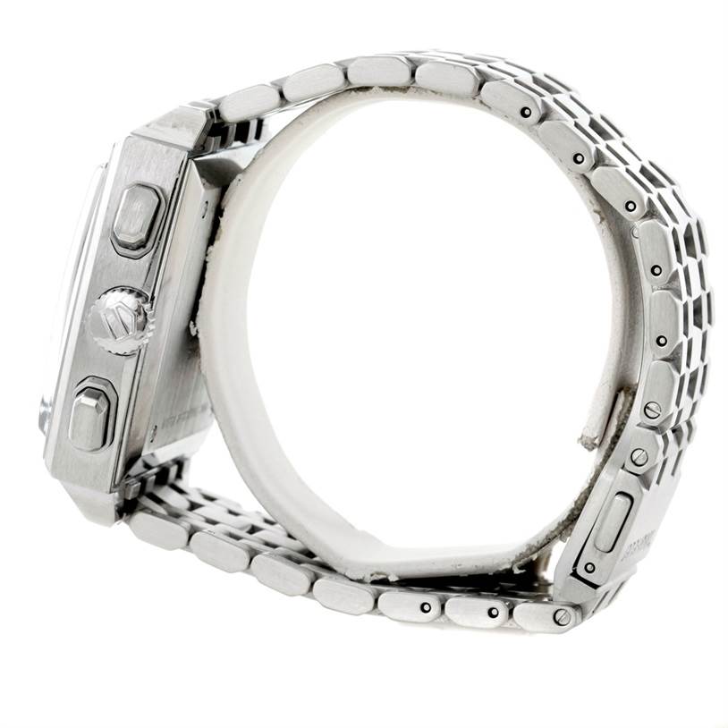 The image shows a side view of a Tag Heuer Monaco CW2113 Men's Stainless Steel Blue Dial CW2113 Men's Stainless Steel Blue Dial watch, highlighting its crown, pushers, and metal bracelet.