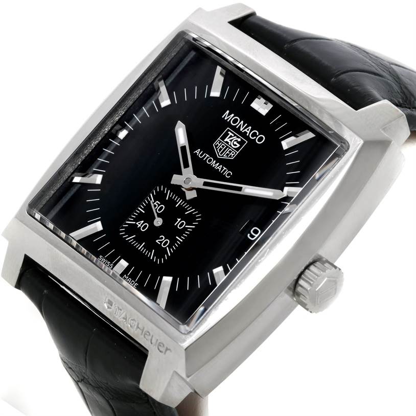 The image shows a close-up of the Tag Heuer Monaco WW2110 Men's Stainless Steel Black Dial WW2110 Men's Stainless Steel Black Dial watch, angled to display the black dial, hands, crown, and part of the leather strap.