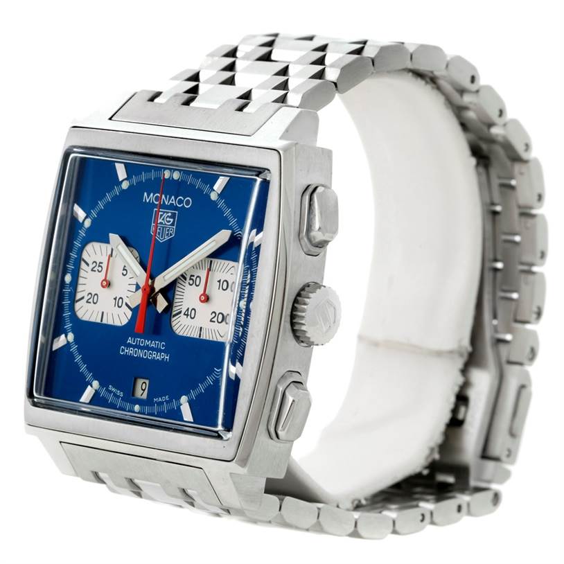 The image shows a side angle of the Tag Heuer Monaco CW2113 Men's Stainless Steel Blue Dial CW2113 Men's Stainless Steel Blue Dial model watch, highlighting its square case, blue dial, crown, pushers, and bracelet.