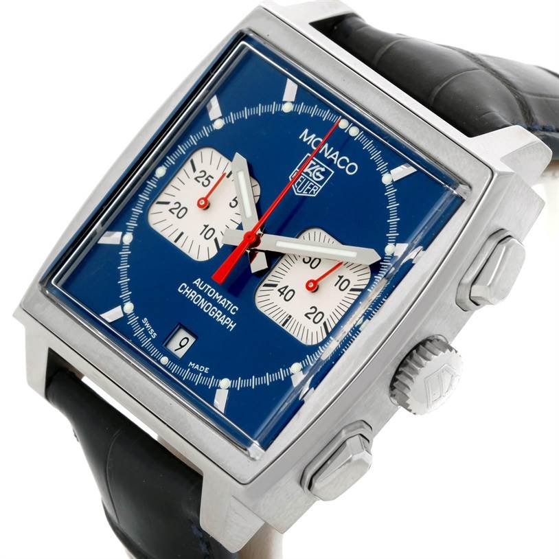 The image shows a Tag Heuer Monaco CW2113 Men
s Stainless Steel Blue Dial CW2113 Men
s Stainless Steel Blue Dial watch at an angled close-up, highlighting its face, crown, and leather strap.